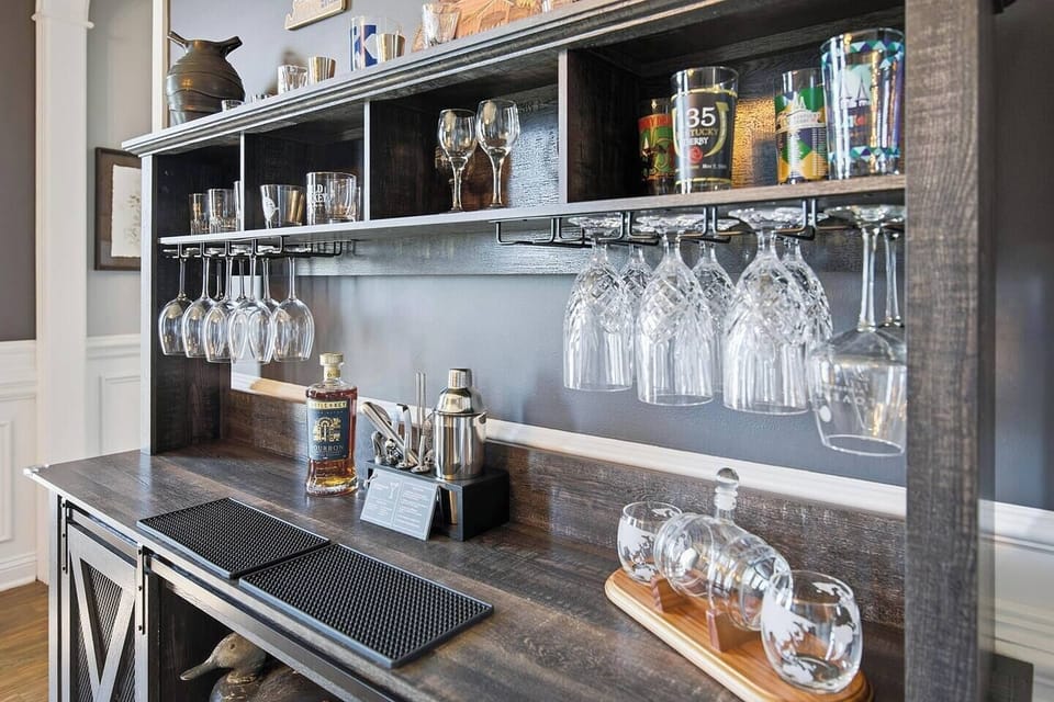 The "Bourbon Room" with poker table and bar cabinet.  Conveniently located just off the kitchen and front foyer with plenty of glassware to enjoy the local distilleries' best finds!