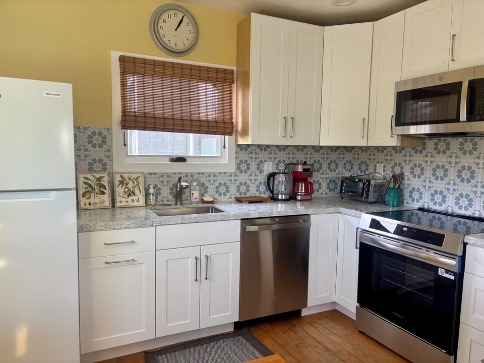 Fully stocked kitchen with induction stove, convection oven & appliances.