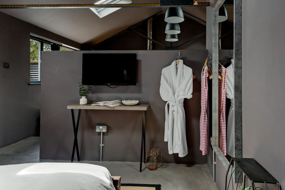 Bedroom with TV and hanging space - The Beam
