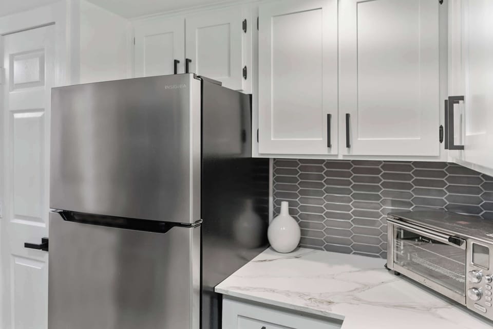 The kitchen is newly remodeled with stainless appliances & new backsplash, making it functional & beautiful. Plenty of cabinet storage space.
