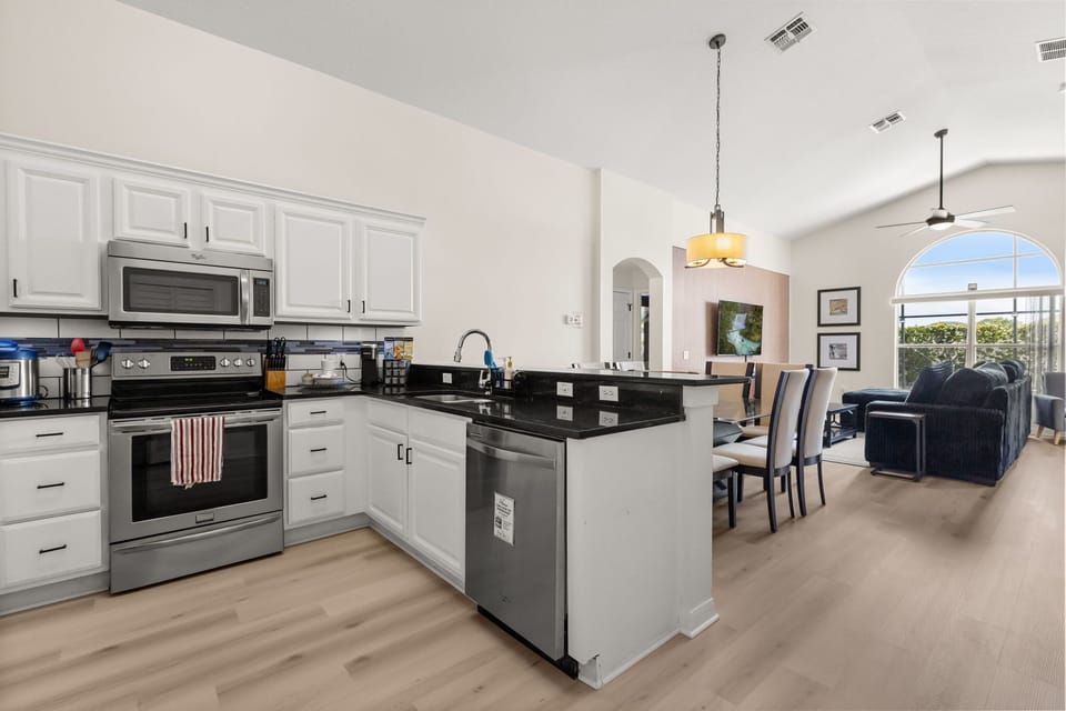 The fully equipped kitchen flows seamlessly into the dining and living spaces, making it easy for families and groups to gather, cook, and connect.