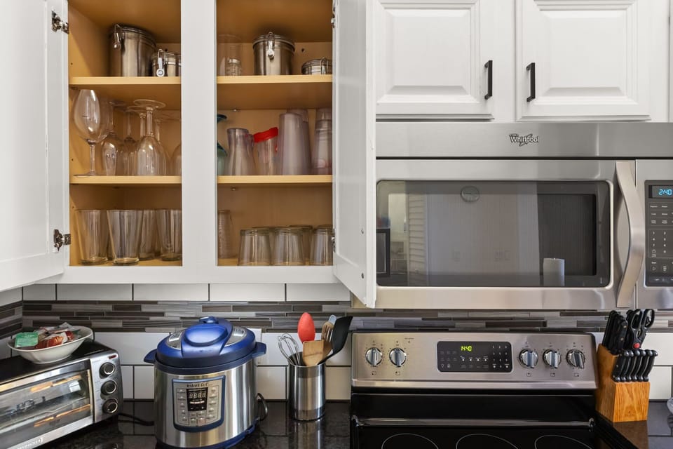 Enjoy the convenience of a well-appointed kitchen featuring glassware, cookware, serving pieces, and everything needed for home-cooked meals.