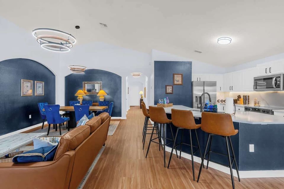 From kitchen to dining table, this open space invites everyone to dine together. Rich blue accents and elegant lighting create a storybook setting for memorable family meals.