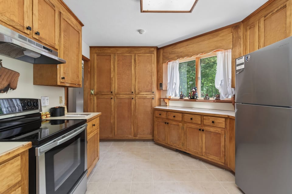 Kitchen: Whip up culinary creations in this spacious, sunlit kitchen with modern appliances!