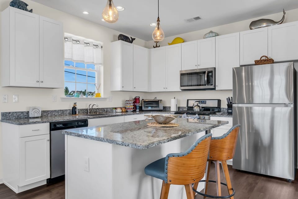 Bright modern kitchen with granite island and stylish breakfast seating