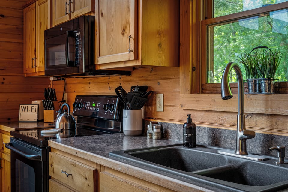 Rustic wood kitchen with full appliances and scenic window views
