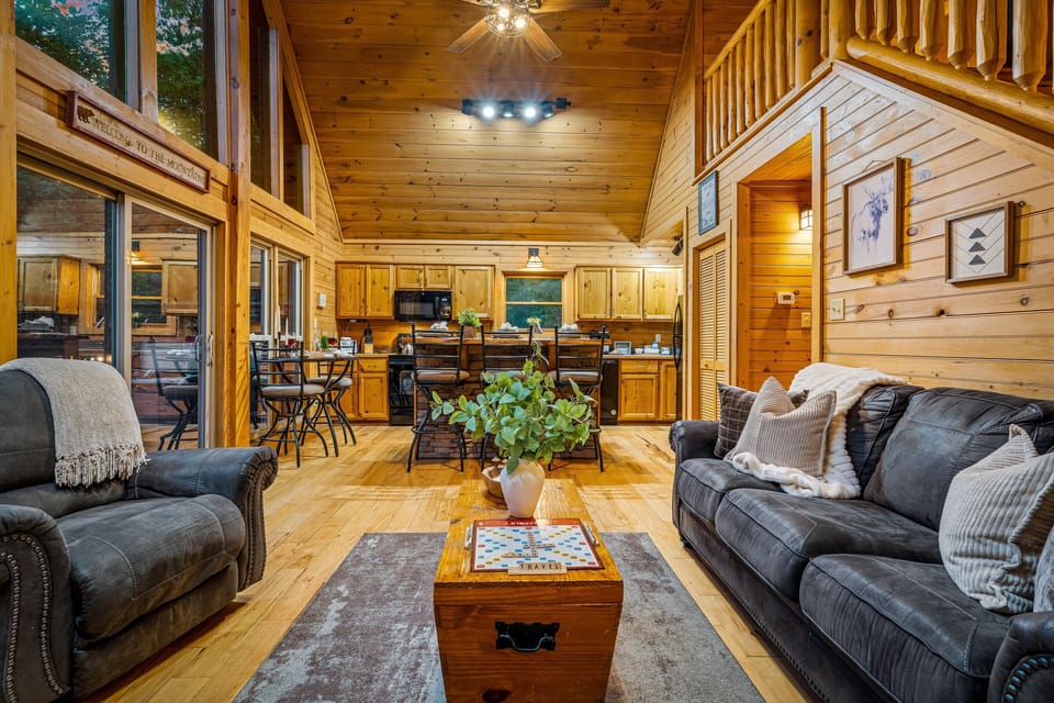 Rustic open-concept cabin with vaulted ceilings, loft, and inviting great room