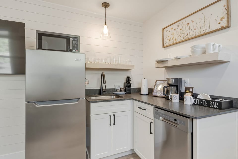 Fully equipped kitchenette with a coffee bar, dishwasher, and essentials for easy meals during your stay.
