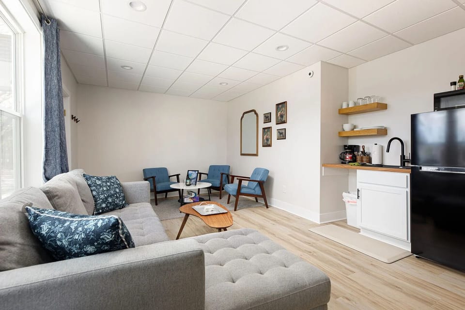 Comfortable living area with a kitchenette, coffee station, full-size fridge, and cozy seating for relaxing between adventures.