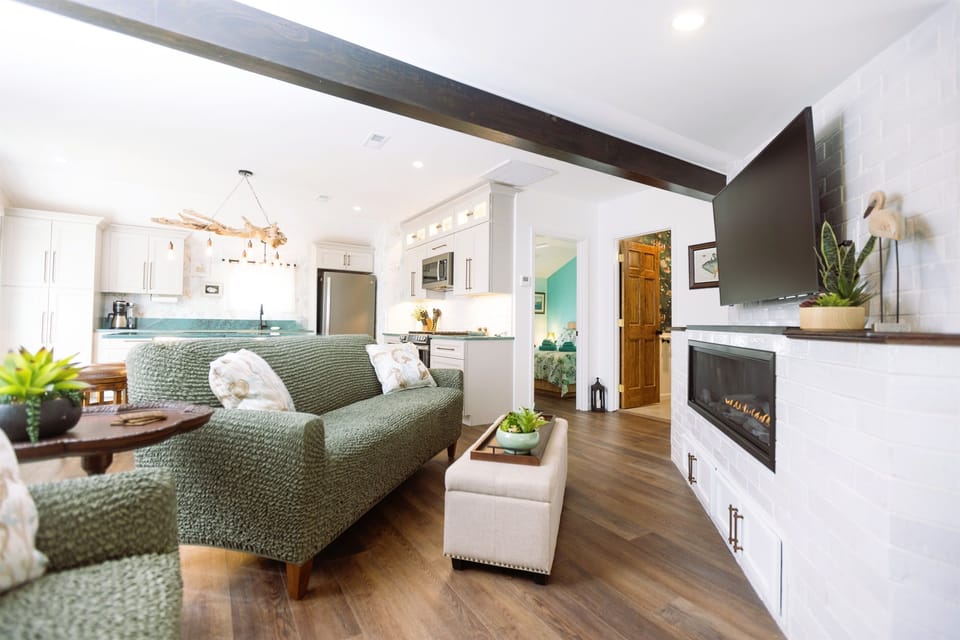The brite open living room featuring a Samsung Frame TV, Linear fireplace, and plenty of space to gather.