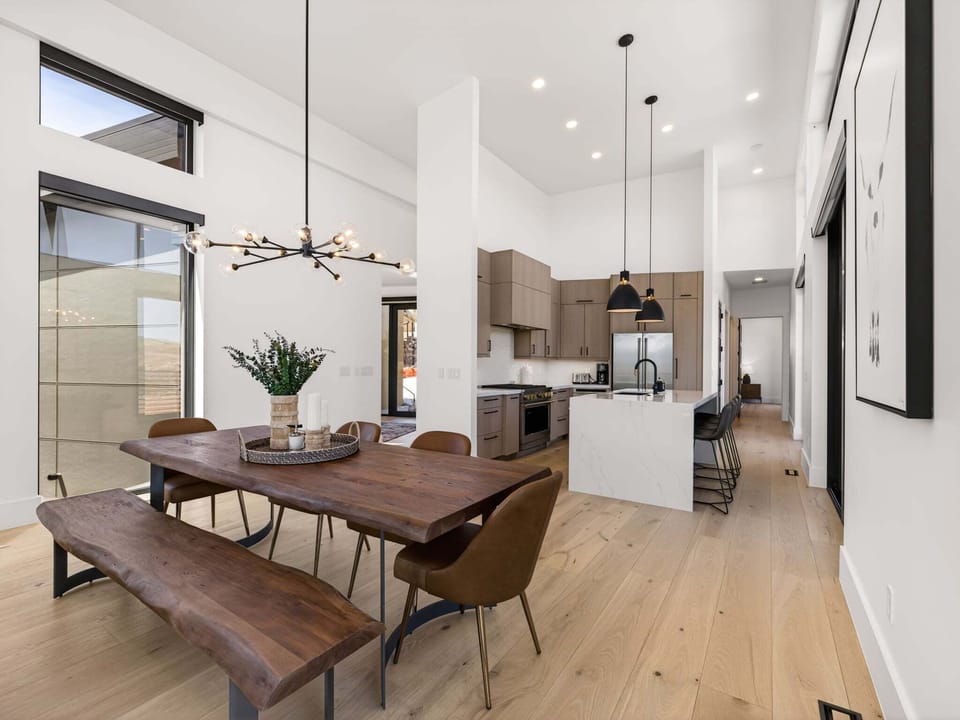 Just off the kitchen is a beautiful custom live edge solid wood table with chairs and bench seating for 8+ as well as 4 barstool seats at the island.