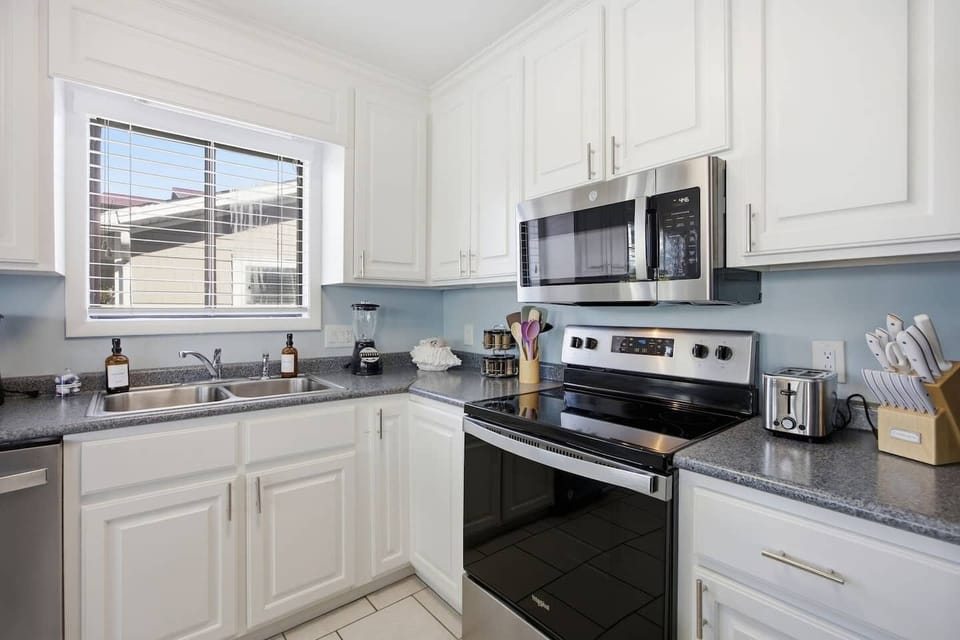 Clean and modern kitchen stocked with essentials for short or extended stays