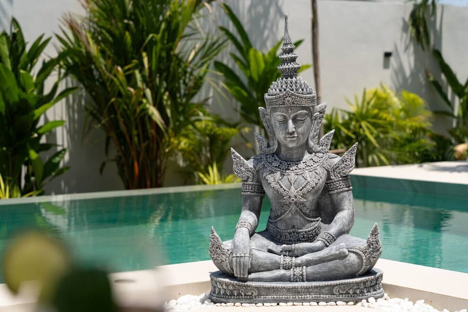 Zen stone statue beside the pool for a serene tropical ambiance at Villa Solunara, Koh Samui