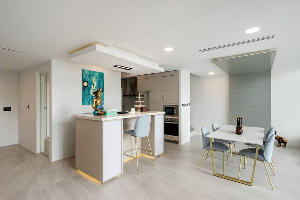 Living and dining area with terrace access at Villa J3, Replay Residence Bangrak Koh Samui
