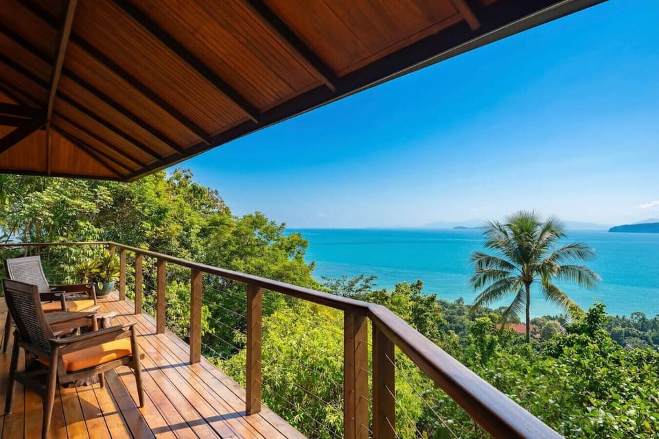 Covered outdoor terrace at Koh Samui vacation villa with stunning Gulf of Thailand ocean panoramas and palm-fringed setting