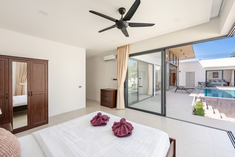 Welcoming guest bedroom suite with air-conditioned comfort, modern decor, and beautiful tropical garden views