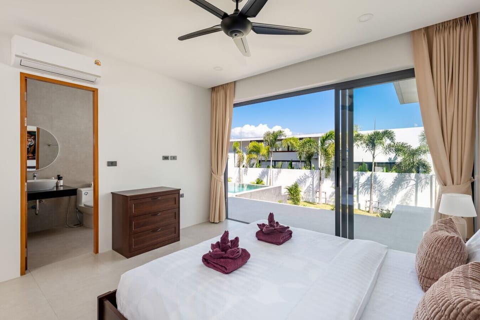 Premium VIP bedroom with king bed, direct pool view, modern air-conditioning, and contemporary Thai decor elements