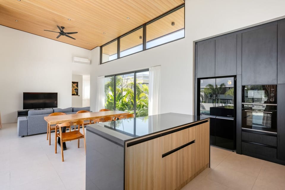 Luxury fully-equipped kitchen with modern finishes, professional-grade appliances, and integrated dining counter