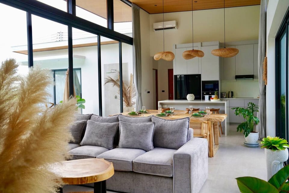 Modern open-plan living room in Koh Samui luxury villa with floor-to-ceiling windows
