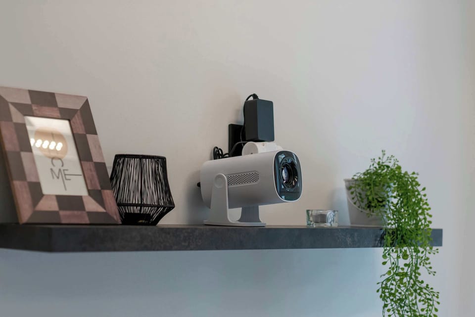 Decorative shelves display framed pictures, books, and small plants against a neutral wall. Simple décor adds personality to the interior.