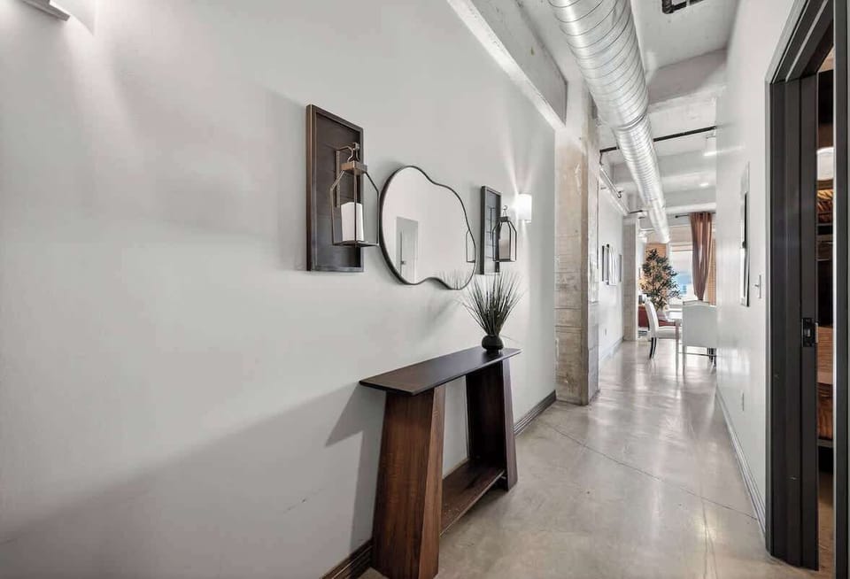 Industrial loft hallway with soaring ceilings - authentic Butler Brothers Building character meets modern comfort.