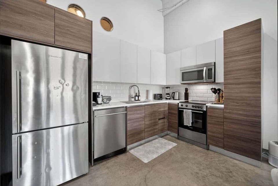 Fully equipped kitchen with warm wood cabinetry - cook family breakfasts or gather around takeout before exploring Dallas.