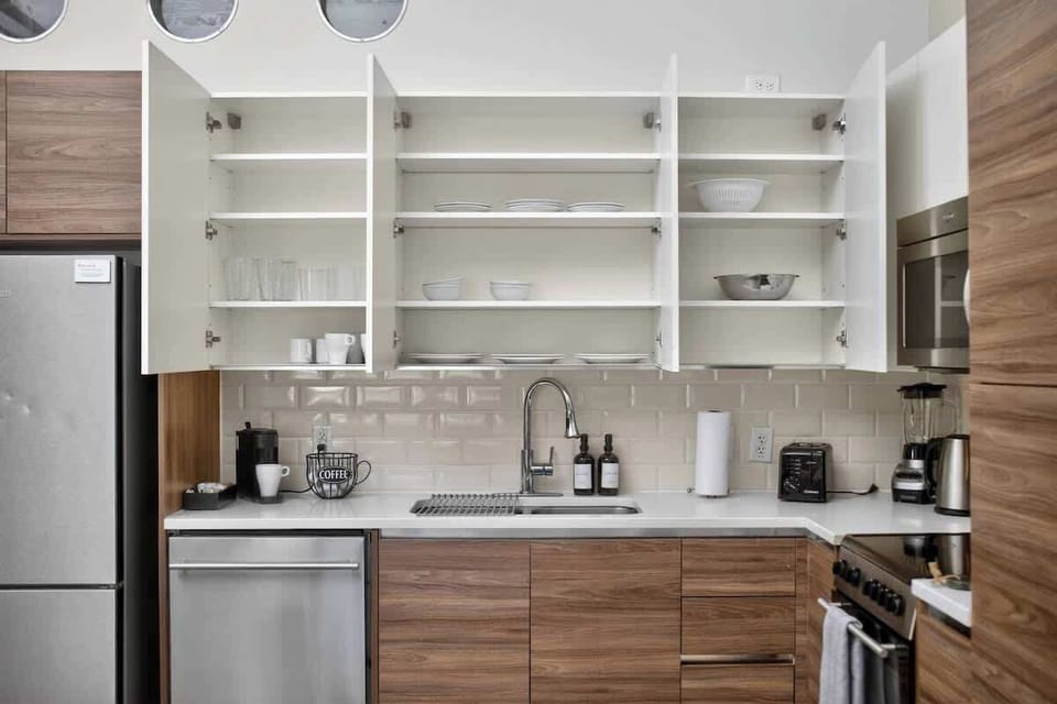 Thoughtfully organized kitchen with complete cookware - everything families need for group meals downtown.