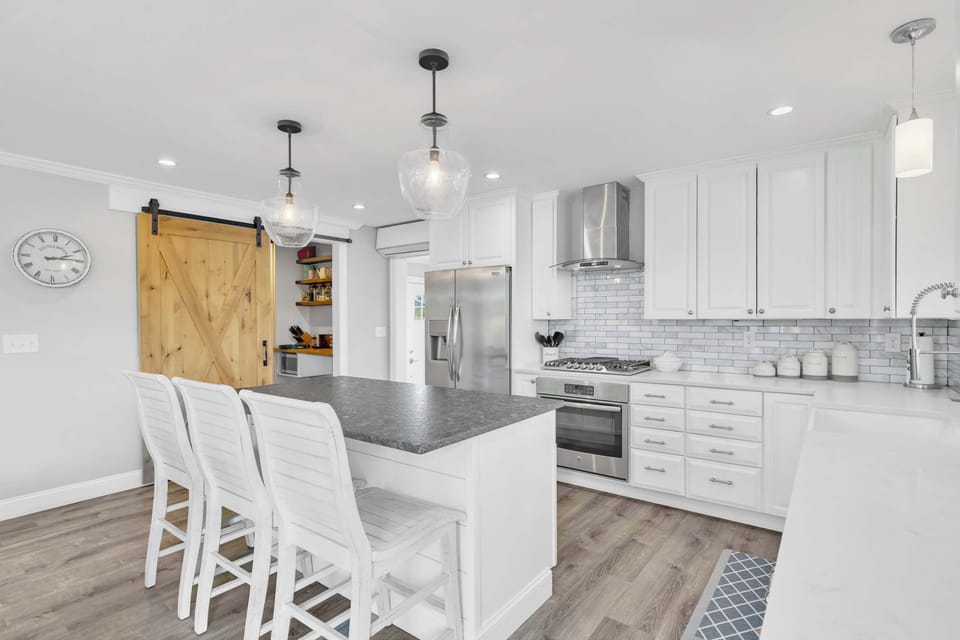 The kitchen has brand new stainless appliances, a spacious island, and walk-in pantry.