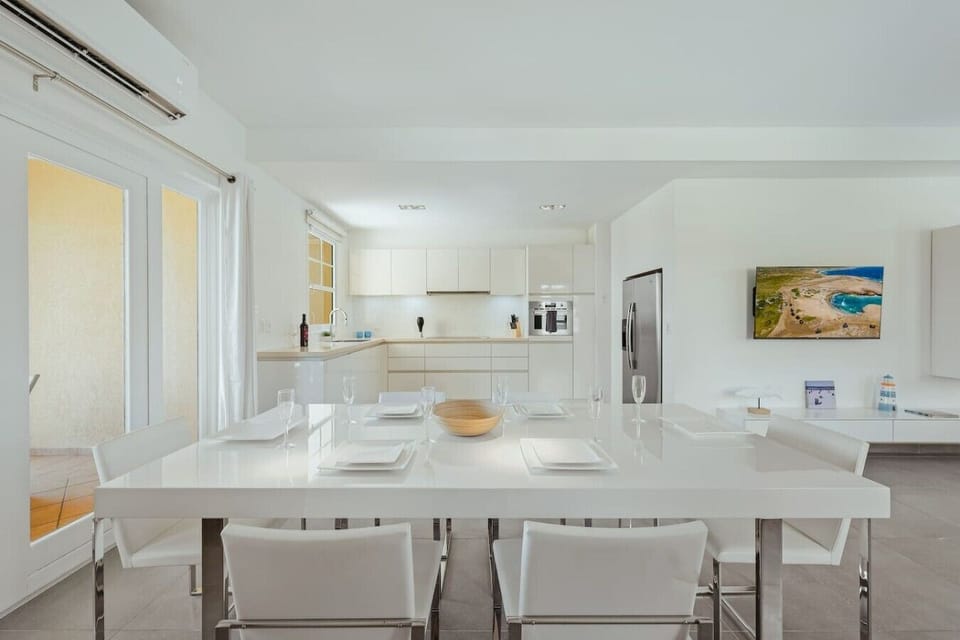 Bright dining area with comfortable seating, perfect for meals, conversations, remote work, and relaxation.