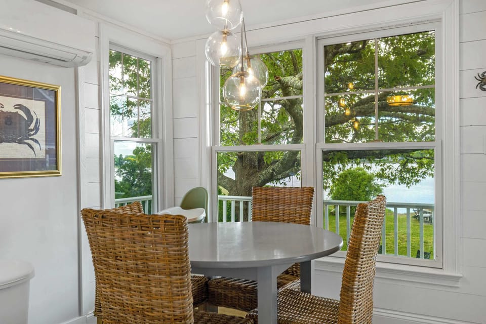 A small dining table overlooks the water, highchair available for the little ones.