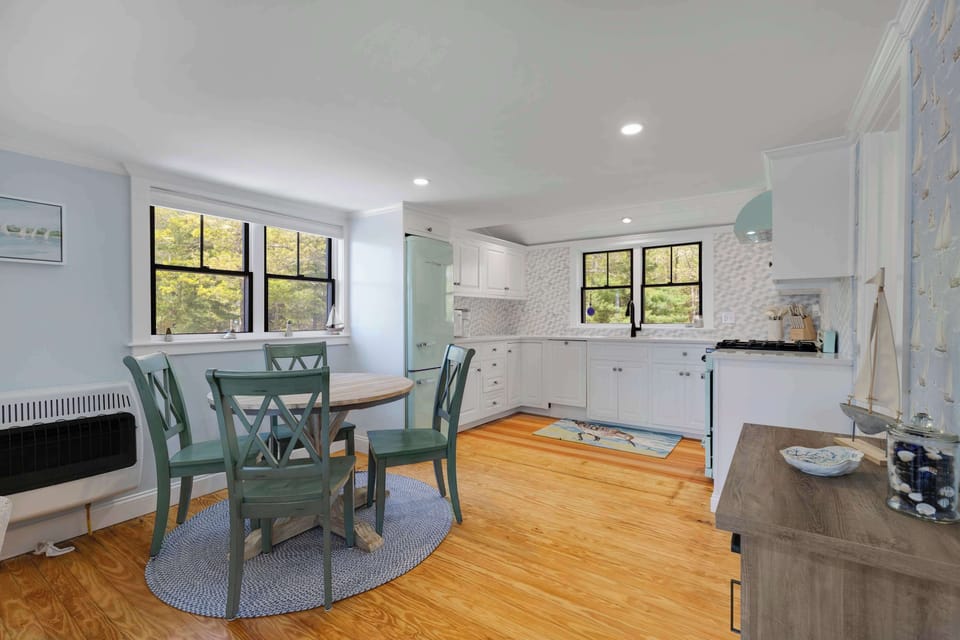 A small dining table sits next to the kitchen. 