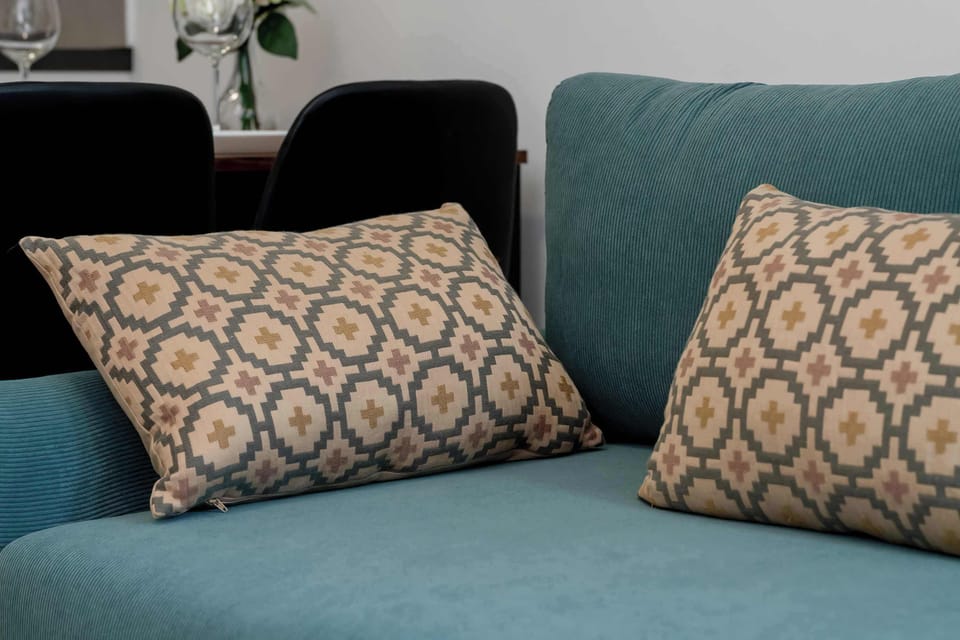 A close-up of decorative cushions on a sofa in the living room. The patterned pillows add a cozy and stylish touch to the interior.
