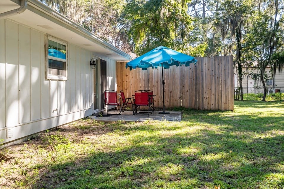 Private patio with seating and umbrella