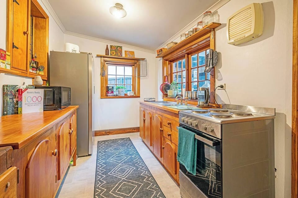 Prepare everything from quick breakfasts to leisurely dinners in a character-filled kitchen where ample storage and modern appliances make cooking feel easy.