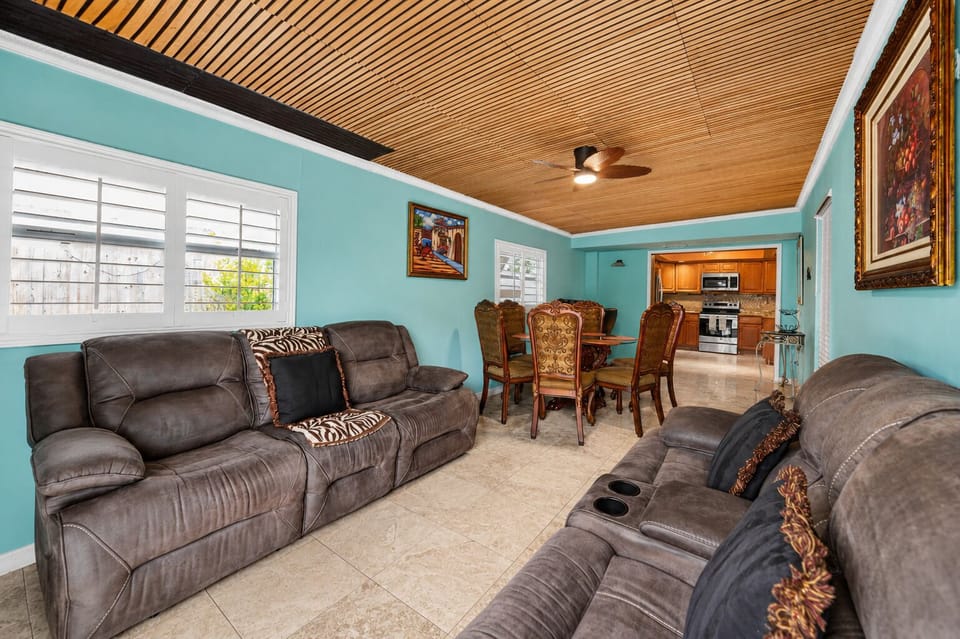 Open-concept gathering space with comfortable reclining sofas and dining seating for the whole group.