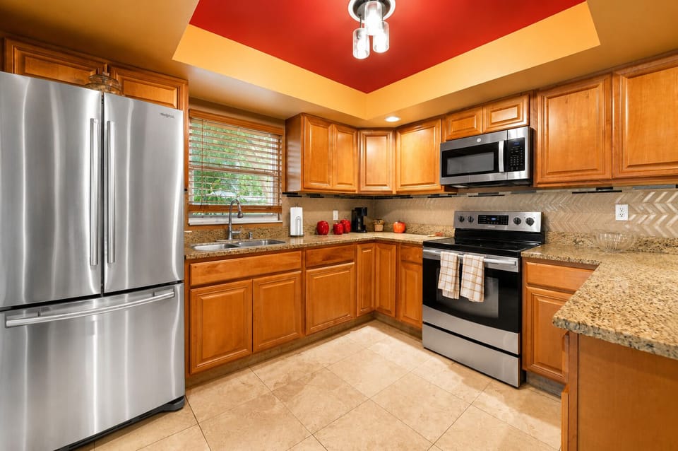 Spacious kitchen featuring stainless steel appliances, granite countertops, and plenty of space for meal preparation.