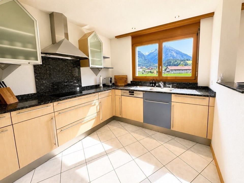 Manor 2 kitchen — fully equipped ground-floor kitchen with Swiss Alps views for relaxed breakfasts and self-catering stays.
