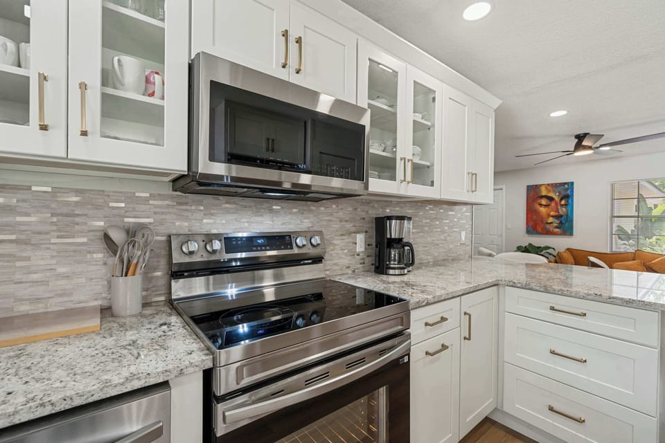 Modern kitchen with stainless steel range & microwave