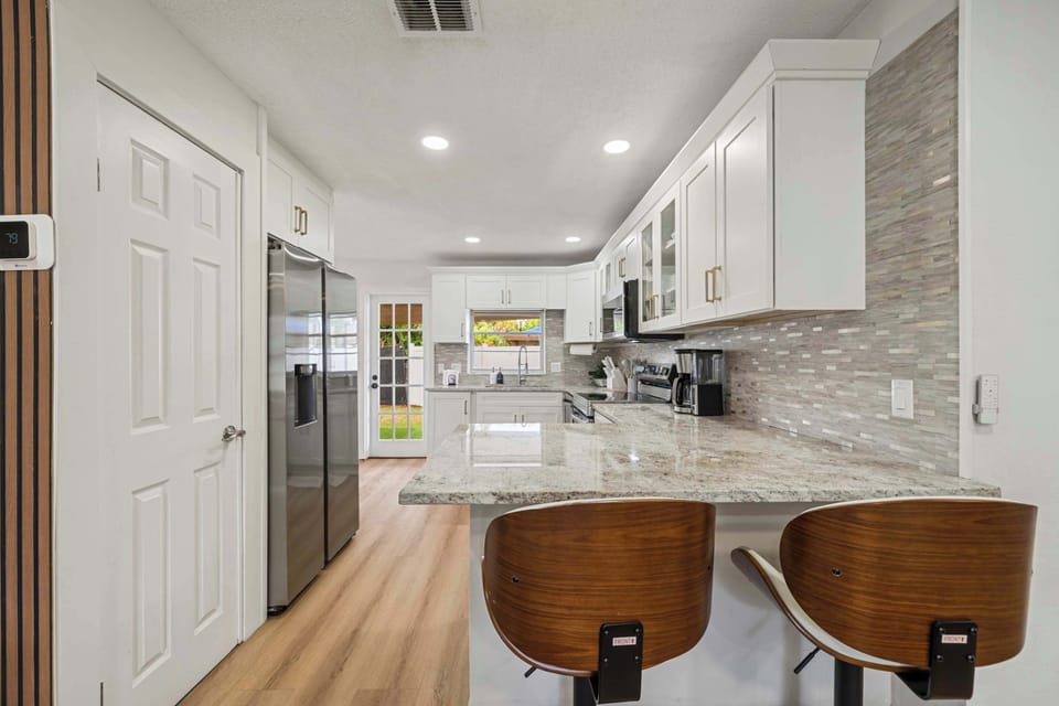 Modern kitchen with granite island & stainless appliances