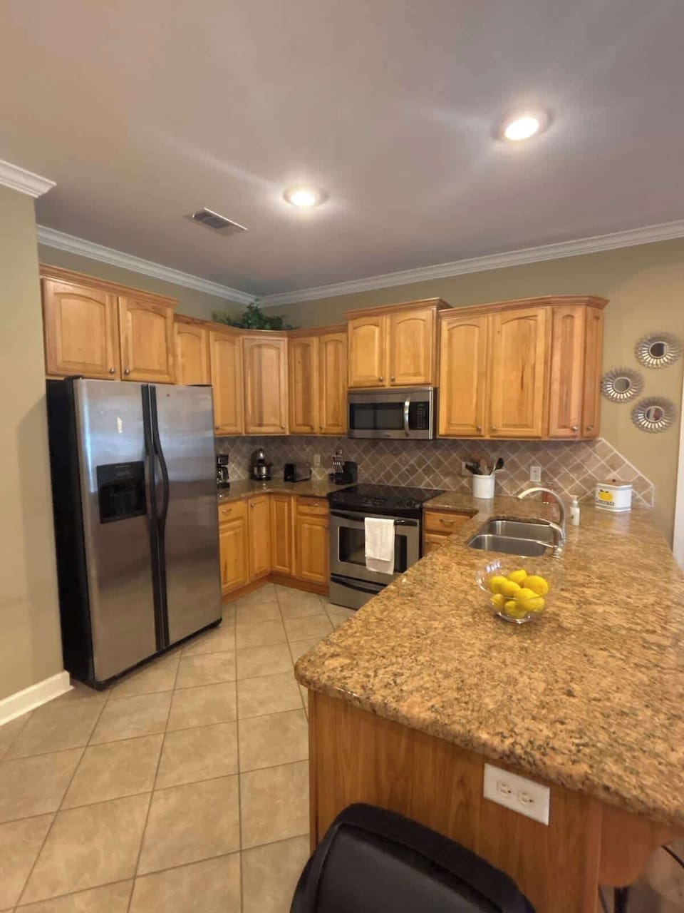 Full Kitchen with 2 barstools - open living and dining area