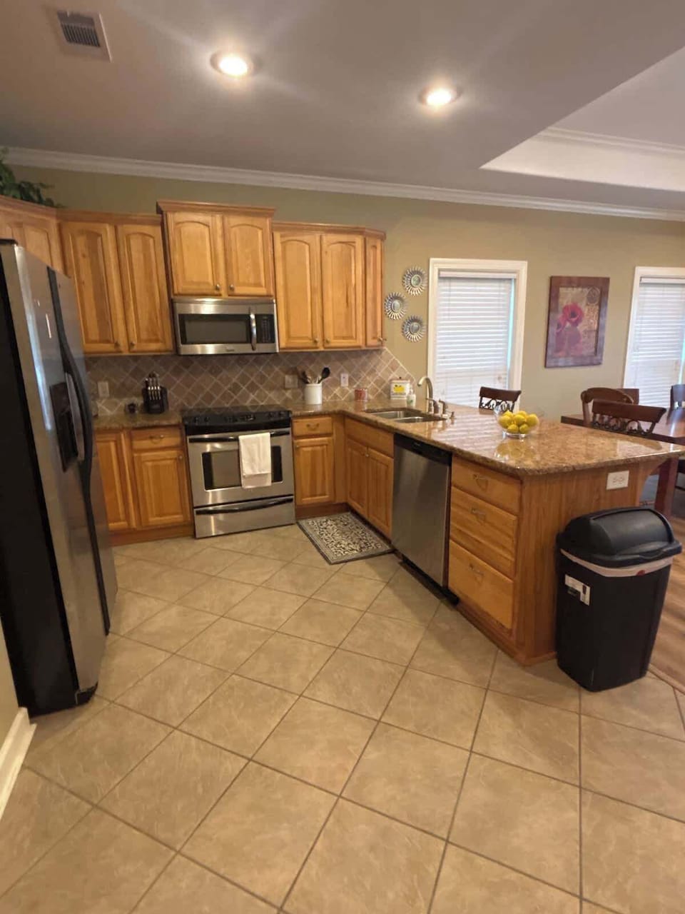 Full Kitchen with 2 barstools - open living and dining area