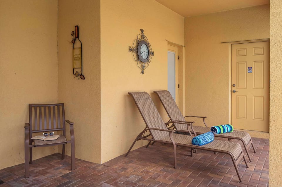 Sunny outdoor lounge area w/ chairs — a relaxed spot to unwind between pool dips.
