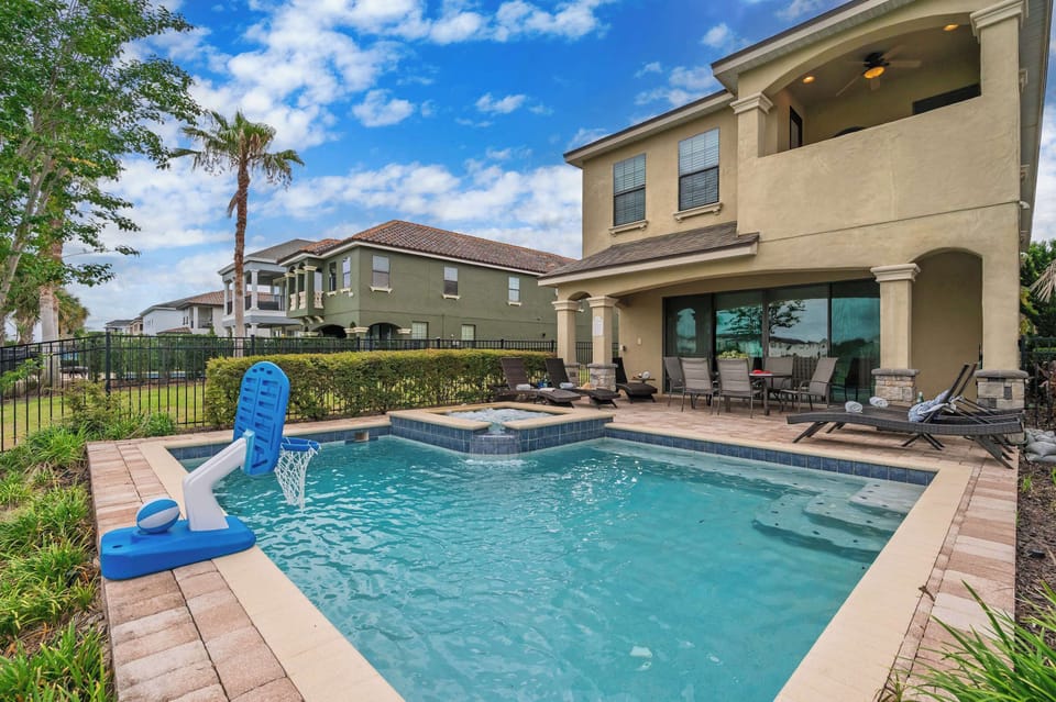 Relax by the private pool with a basketball hoop and spacious patio seating.