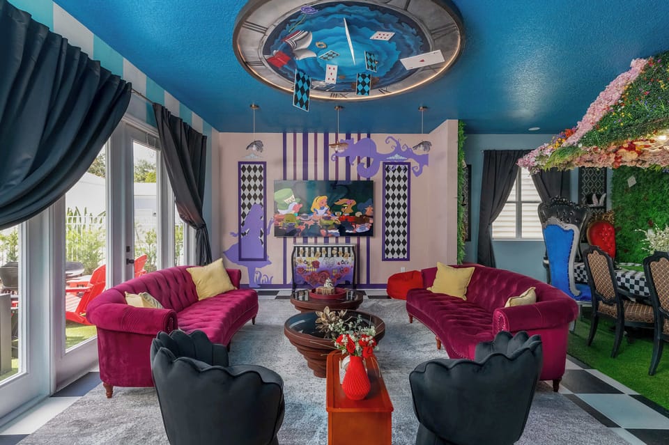 Enjoy a whimsical living room with vibrant velvet seating and an alice in wonderland-themed ceiling mural.
