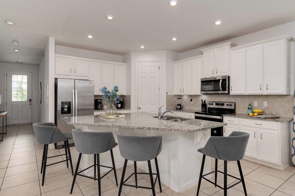 Modern kitchen with granite island and stainless steel appliances