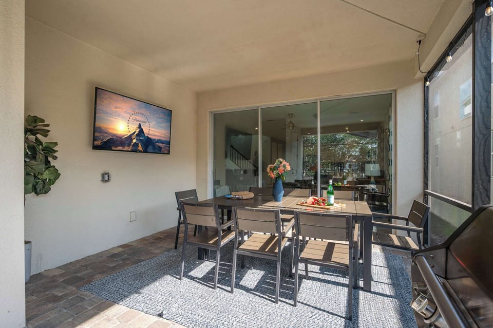 Enjoy outdoor dining and entertainment on the covered patio with a mounted TV and seating for eight.