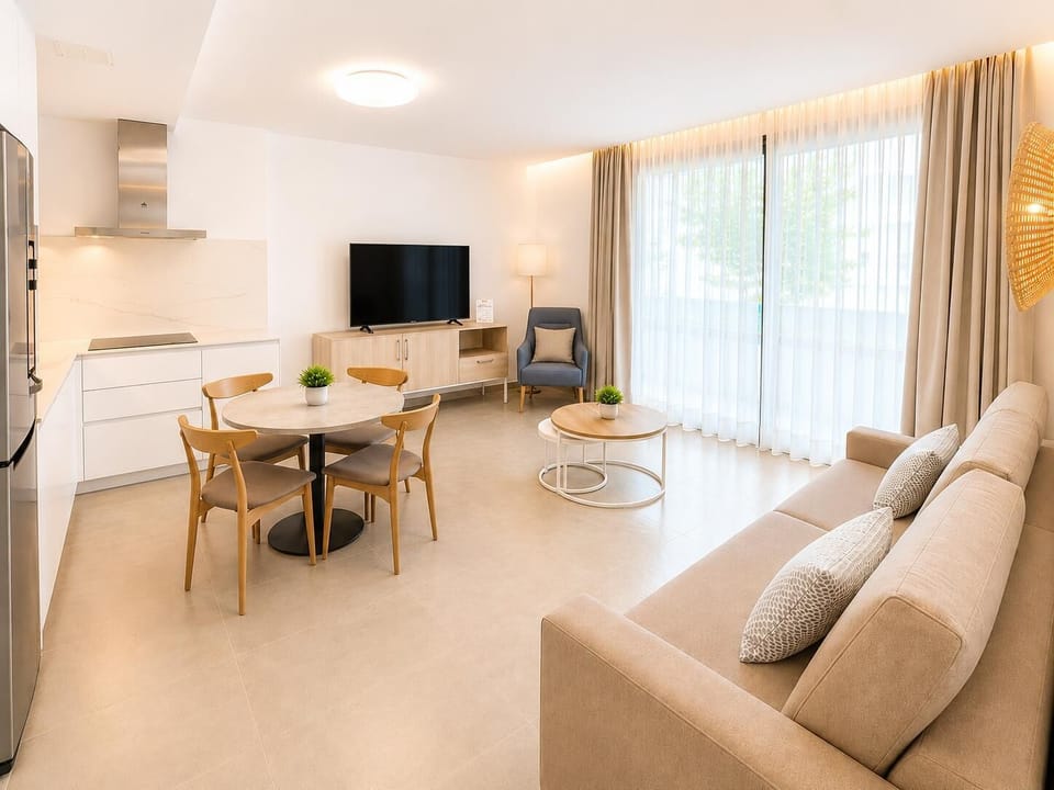 A bright modern open-plan living area with a stylish kitchen, dining space.