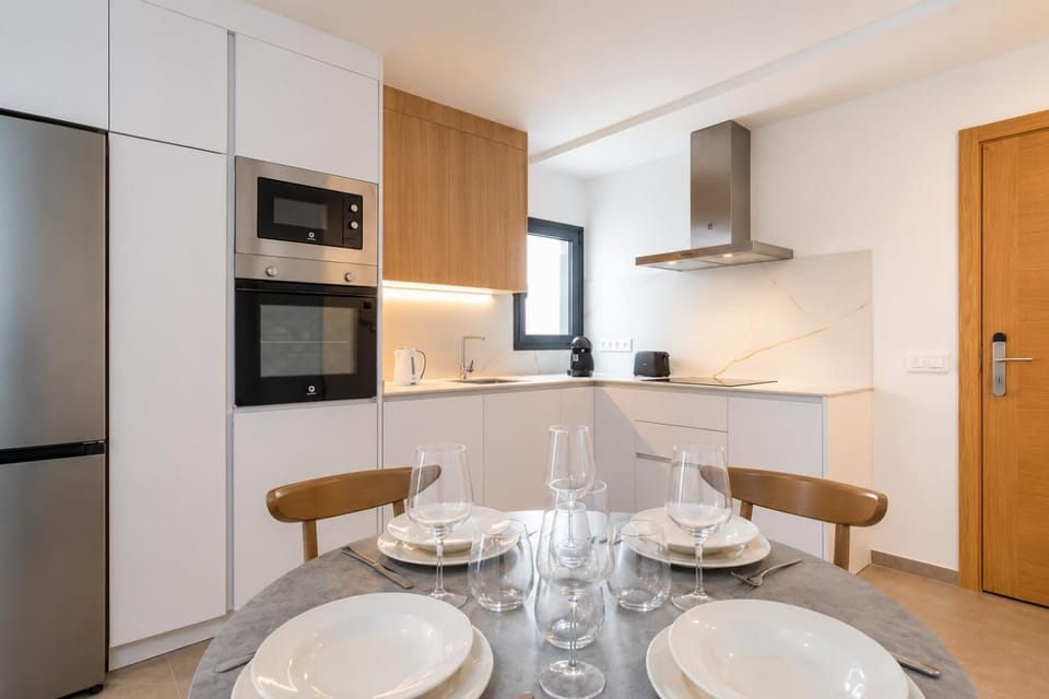 A modern open-plan living and dining area with elegant neutral decor.