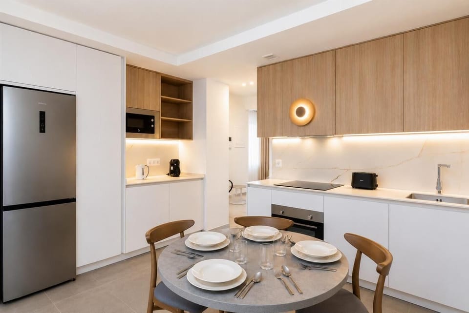 A bright modern open-plan living area with a stylish kitchen, dining space.