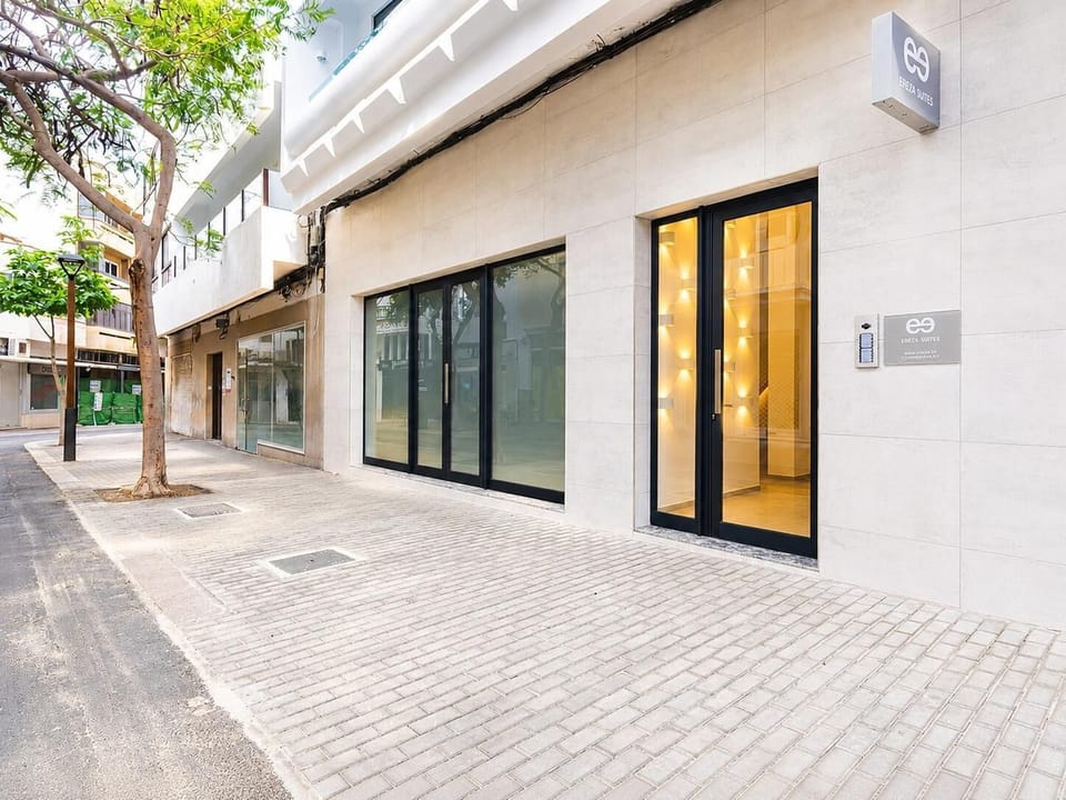 A sleek modern suite entrance with stylish signage and a clean city-street setting.